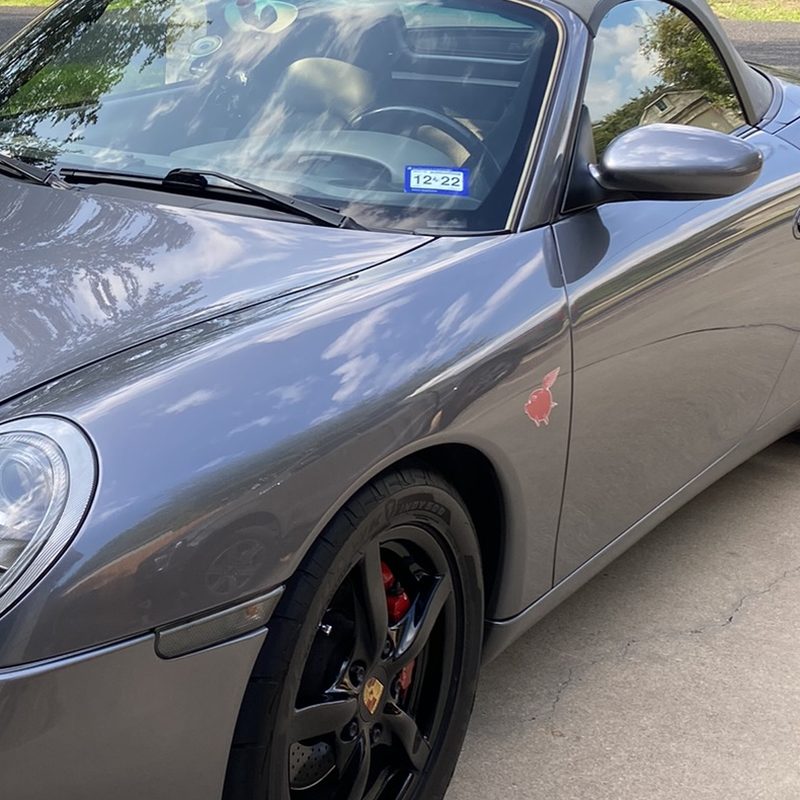 Dillo sticker on a grey Porsche Boxster S fender