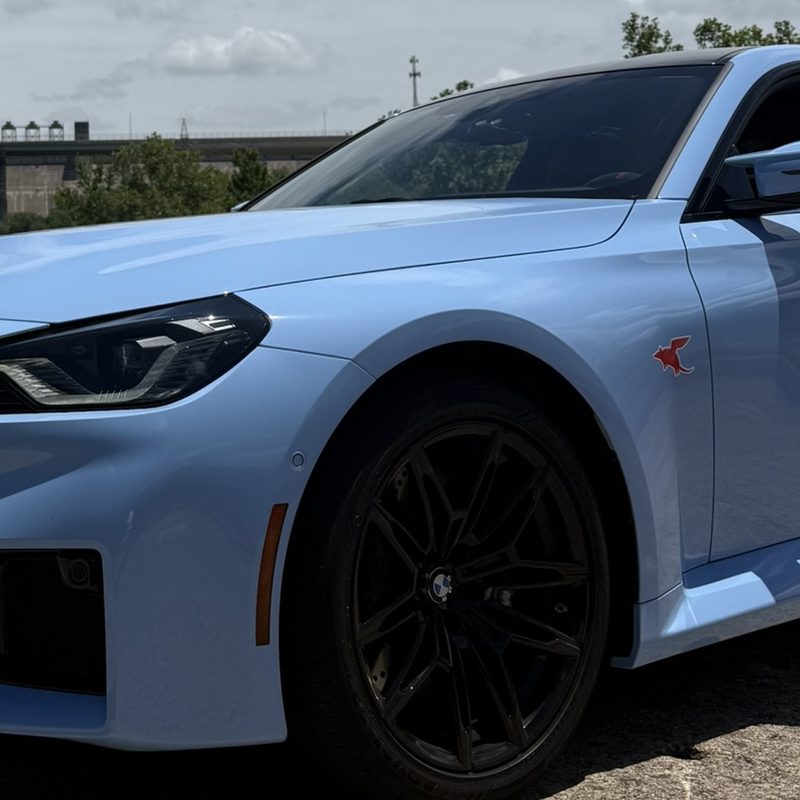 Dillo sticker on a light blue BMW M2 at Mansfield Dam
