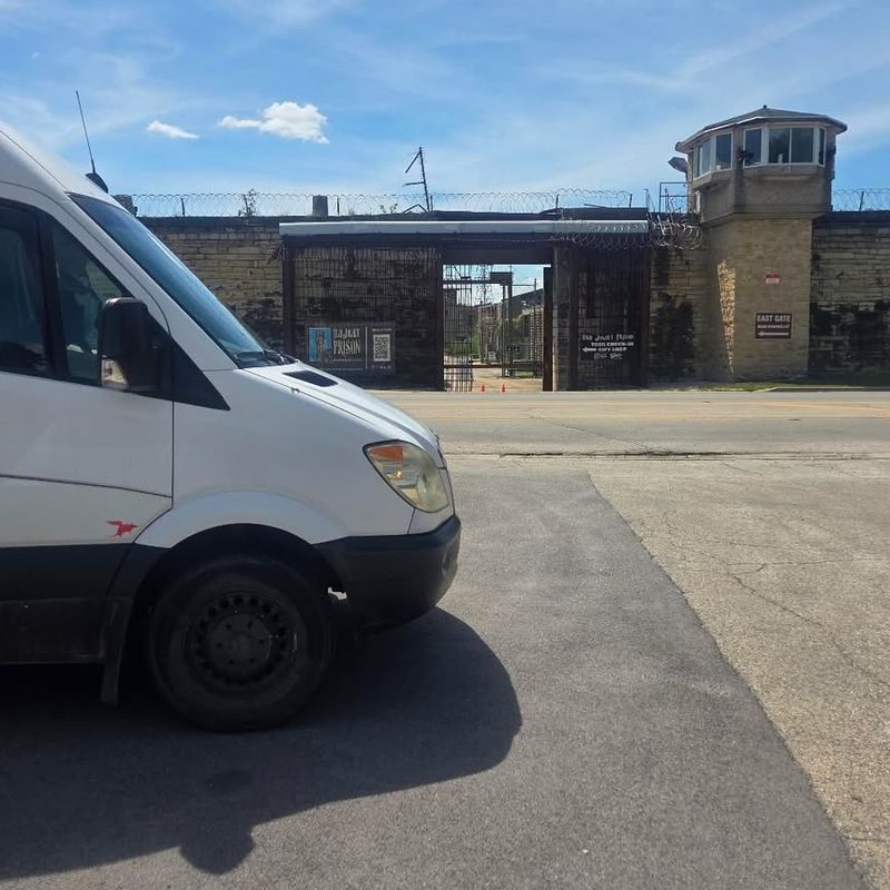 Dillo sticker on a white Sprinter van outside the old Joliet prison